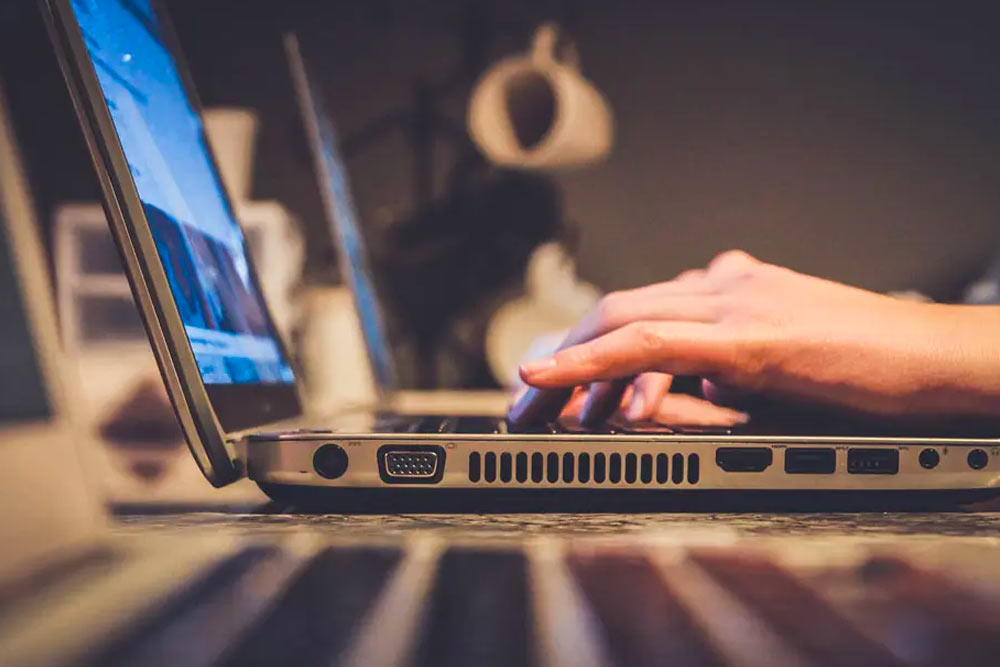 a person typing on a laptop.